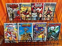 Rack displaying eight bagged and boarded #1 issue comic books