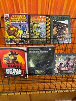 All six books displayed on wire rack