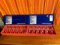 Both boxes opened, displaying twelve crystal wine glasses