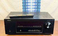 Front view of Denon AVR-1913 receiver with remote on top