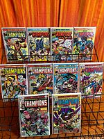 Front view of eleven bagged The Champions comics on rack