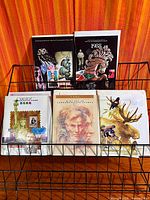 Front view of rack holding several USPS Mint Set booklets