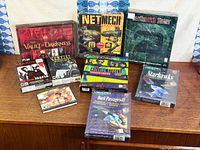 Overall view showing nine boxed PC titles on wooden surface