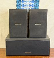 Front view of two bookshelf speakers stacked on center speaker showing Pioneer logos