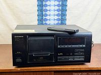 Front view of Pioneer PD-F605 CD player with remote on top