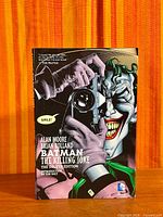 Front cover showing Joker with camera, full dust jacket visible