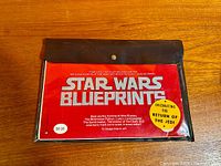 Front view of vinyl sleeve showing red insert with Star Wars Blueprints title