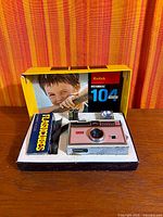 Camera, flashcubes box, batteries and original packaging overview