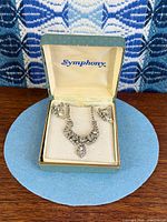Necklace and earrings displayed in Symphony box