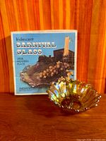 Boxed hostess plate beside iridescent bowl