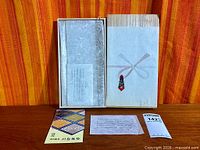 Closed wooden box with contents and paperwork laid out