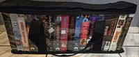 Full view of vinyl bag containing multiple VHS tapes