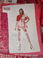 Packaged image showing model wearing Miss Red Riding Hood costume by California Costumes