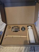 Open box with zen garden components arranged in cut-outs