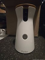 Front view showing camera lens, treat opening and Furbo logo