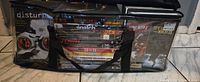 Front view of bag showing stacked DVDs with titles visible