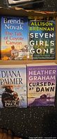 All four paperback novels front covers visible in box