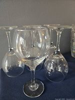 Front view showing one upright glass and four inverted glasses for clarity of bowl and stem design