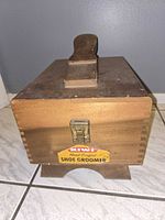 Closed wooden shoe groomer box showing Kiwi label and latch