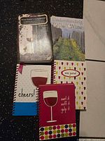 Front covers of two books and three journals showing titles and wear