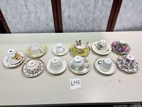 All 11 teacup and saucer pairs displayed on table