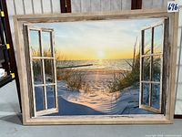 Front view of framed canvas showing beach sunset scene and faux window frame