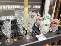 All 16 pieces displayed on shelf: six goblets, six cordials, four tumblers with tissue