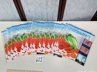 Front view of 14 sealed chopping-mat packages arranged in a fan layout showing identical packaging and graphics