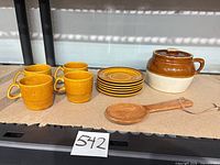 Full lot showing four cups, six saucers, bean pot with lid, spoon holder