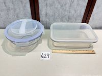 Both containers side by side with ruler for scale