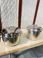 Both stockpots with lids displayed side by side for size comparison