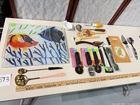 overview of entire lot showing glass fish boards, utensils, packaged tools