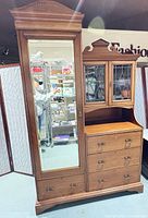 Full view of assembled chifforobe showing wardrobe, bureau, mirror, glass doors and drawers