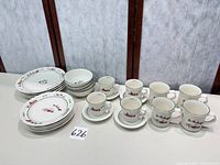 Group shot showing all pieces: plates, bowls, cups, saucers, mugs