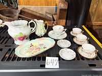 All eleven porcelain pieces on shelf