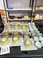 Packaged and loose cream interior dark rim ramekins in foreground