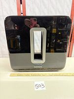 Front view of Sonos Sub Gen 1 showing glossy black finish and central port