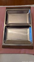 top view of two-section stainless steel tray with wooden handles
