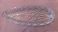 Top view of large cut-crystal oval dish showing starburst and diamond pattern