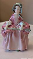 Front view of Royal Doulton Bo Peep figurine showing dress, bonnet, and crook