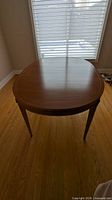 Oval cherry wood dining table top view