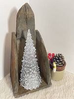 Front view showing pine candle holder with props for scale