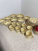 Group view of entire Johnson Bros Old Chelsea set showing cups, bowls, plates