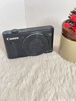 Front view of Canon PowerShot SX610 HS camera with lens retracted