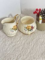 Creamer and sugar bowl together showing pattern and shape