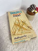 Front angle of boxed Double Pick-Up Sticks game