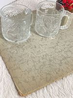 Pair of clear embossed Batman Forever glass mugs on surface