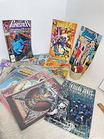 Group shot of all fourteen comics standing and fanned out