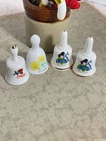 Four miniature Birchcroft bells showing fronts and motifs