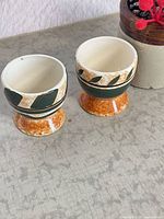 Two ceramic egg cups front view showing design